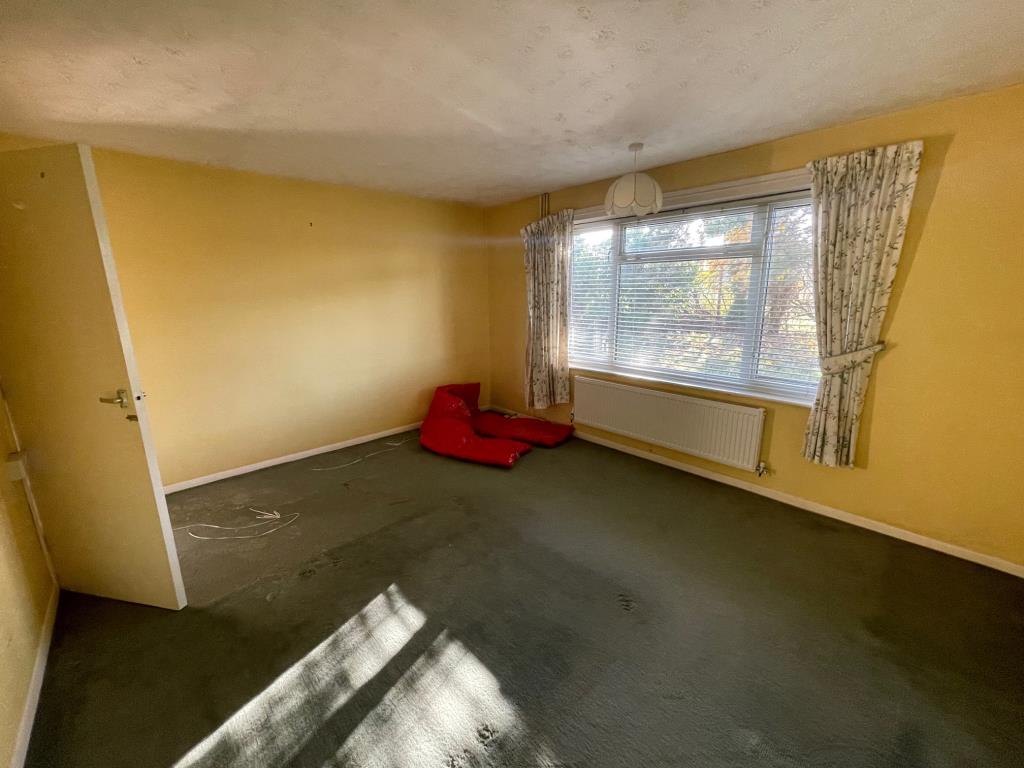 Lot: 76 - A DETACHED BUNGALOW FOR IMPROVEMENT AND REPAIR - Bedroom 1 with window looking on to the garden
